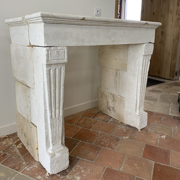finely carved limestone fireplace