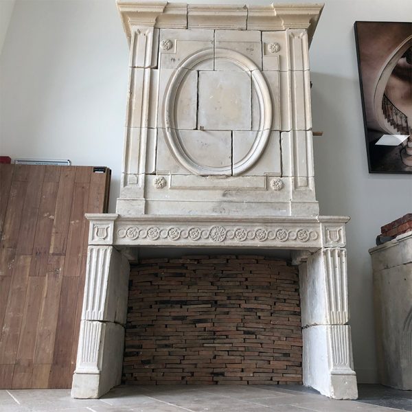 Reclaimed antique Louis XVI style stone fireplace with overmantel