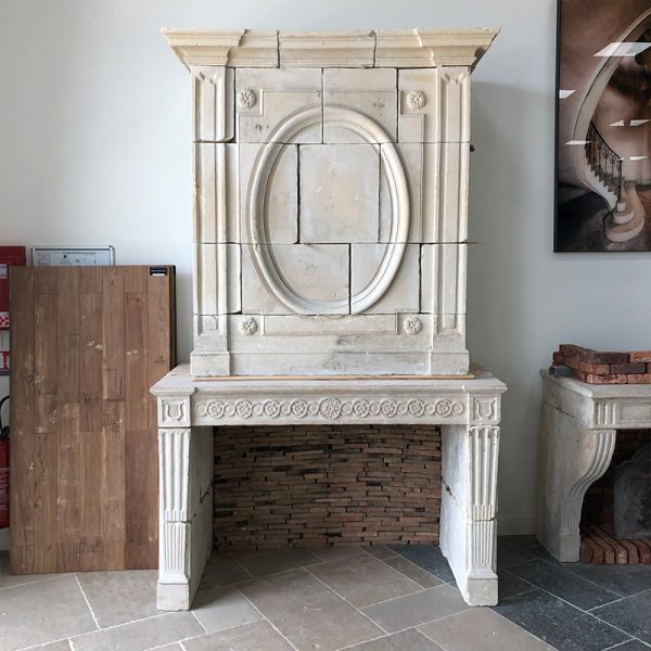 Stone fireplace with carved overmantel